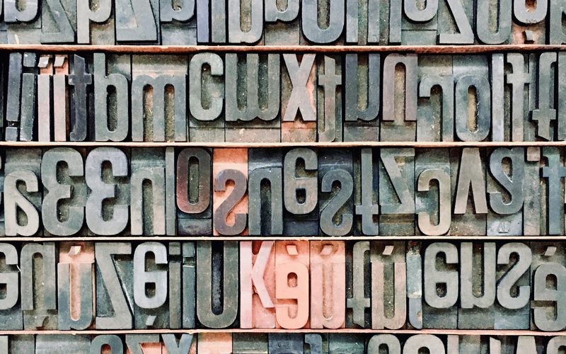 Wall of letterpress type — the craft of corporate identity