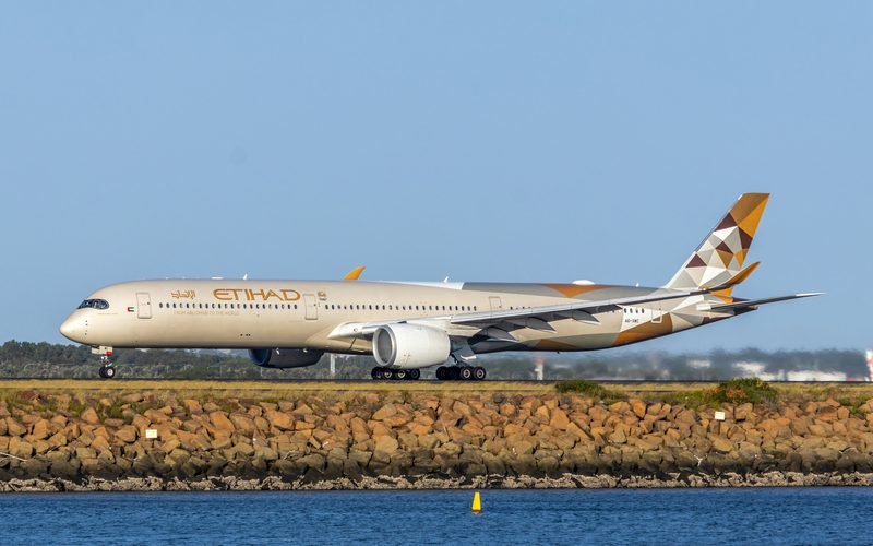 Etihad Airways aircraft on the runway at golden hour